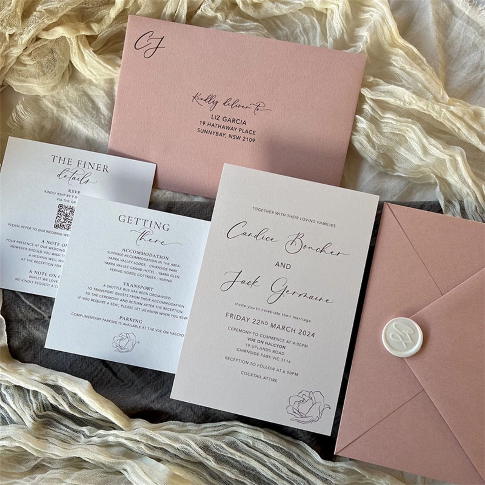 Printed wedding invitation suite with dusty pink envelopes and wax seal